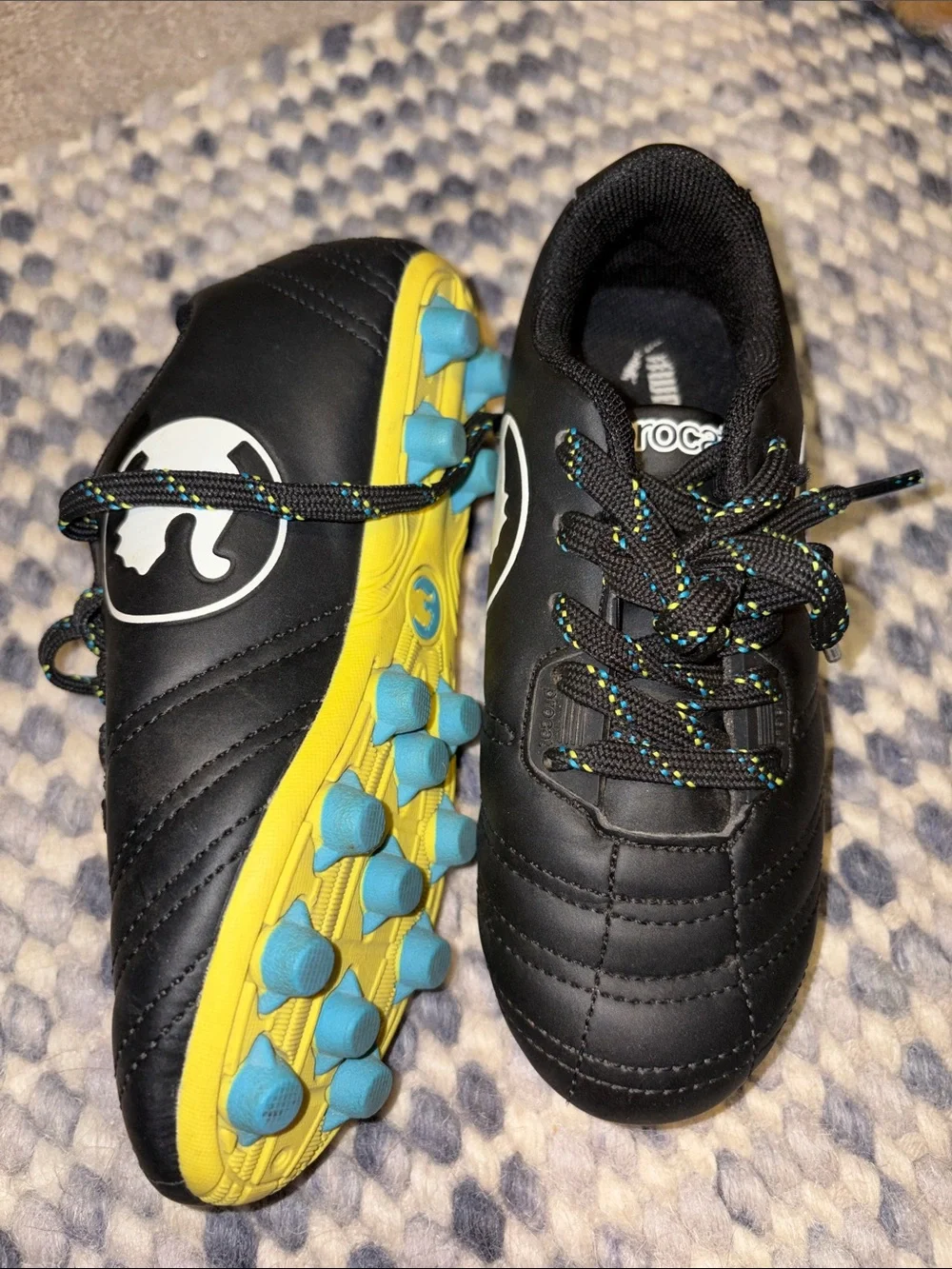 Puma Kids Black Soccer Cleats with Yellow Sole and Blue Studs